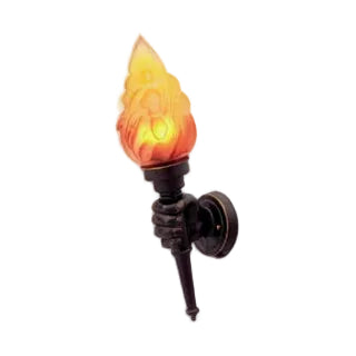 A gothic-style wall sconce featuring a dark bronze hand holding a flaming torch with a glowing yellow and orange flame-shaped glass shade, mounted on a round wall plate.