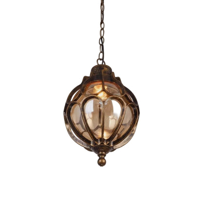 An antique bronze hanging lantern light fixture with a warm glowing bulb inside, set against a plain white background.