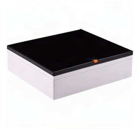 A rectangular storage box with a glossy black lid and a white base, featuring a small orange accent tab on the front of the lid, shown on a plain white background.